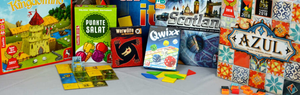 Spiele für Kinder ab 8 unter anderem Werwolf, Scotland Yard, Punktesalat und Qwixx